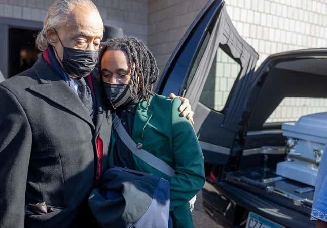 Amir Locke’s brother, Andre Locke Jr., is comforted by the Rev. Al Sharpton after his casket is placed into the hearse following Amir Locke’s funeral at Shiloh Temple International Ministries, Thursday, Feb. 17, 2022, in Minneapolis, Minn. Locke was killed Feb. 2 by Minneapolis police as they executed a no-knock search warrant.