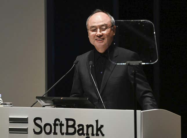 Masayoshi Son speaking on a podium that says SoftBank