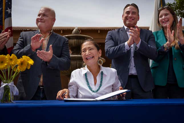 Interior Secretary Deb Haaland smiles after signing Public Land Order 7940, which protects more than 4,200 acres of Bureau of Land Management-managed public lands that is sacred to Tribes in the Placitas area, during a community event at El Zócalo Plaza in Bernalillo, N.M., Thursday, April 18, 2024. For the next 50 years, the lands will be closed to new mining claims, mineral sales, and oil and gas leases. (Chancey Bush/The Albuquerque Journal via AP)