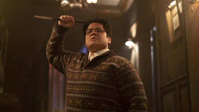 Guillermo raises a wooden stake in his trademark sweater on What We Do in the Shadows.