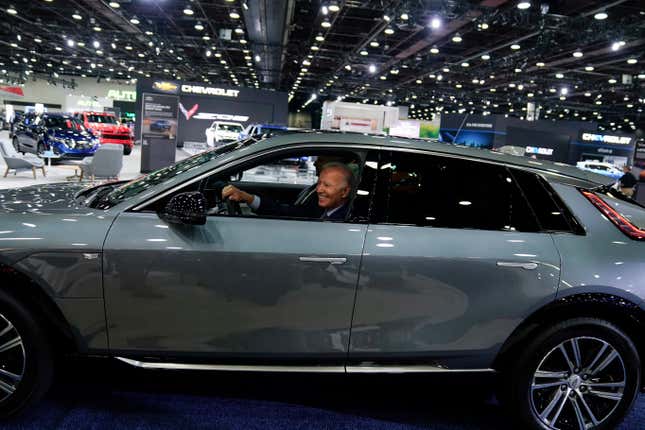 FILE - President Joe Biden drives a Cadillac Lyriq through the show room during a tour at the Detroit Auto Show Sept. 14, 2022, in Detroit. (AP Photo/Evan Vucci, File)