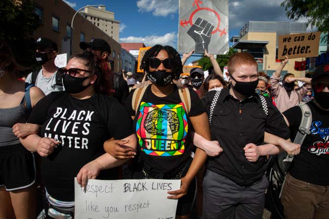 Protesters march arm in arm during a demonstration against racism and police brutality in Pittsburgh, Pennsylvania, on June 6, 2020. 