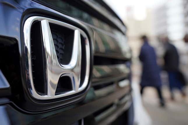 FILE - People walk near the logo of Honda Motor Company at a showroom on Feb. 8, 2022, in Tokyo. Honda has reported that its profit jumped 34% in July-September 2023 from a year earlier as a cheap yen helped boost the Japanese automaker’s overseas strong earnings thanks to healthy demand, especially in the U.S. (AP Photo/Eugene Hoshiko, File)