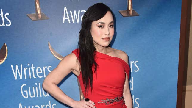 Ivory Aquino wears a one-shoulder red dress with sparkling waist detail on the red carpet.
