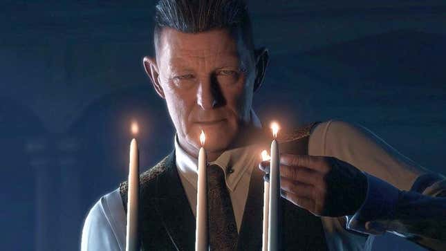 A man in a suit lights candles in the dark