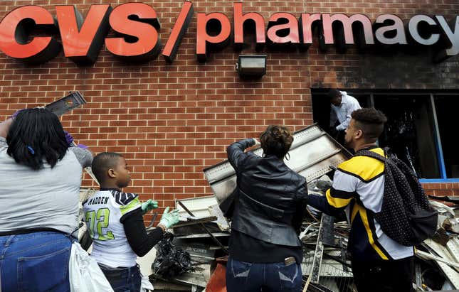 Citizens help clean a CVS that was looted.