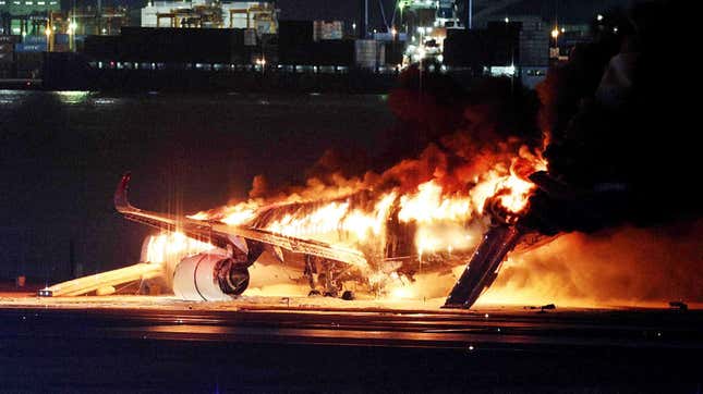 This photo provided by Jiji Press shows a Japan Airlines plane on fire on a runway of Tokyo's Haneda Airport on January 2, 2024.