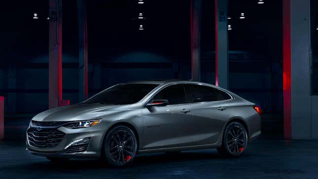 a silver chevy malibu parked in a dark setting