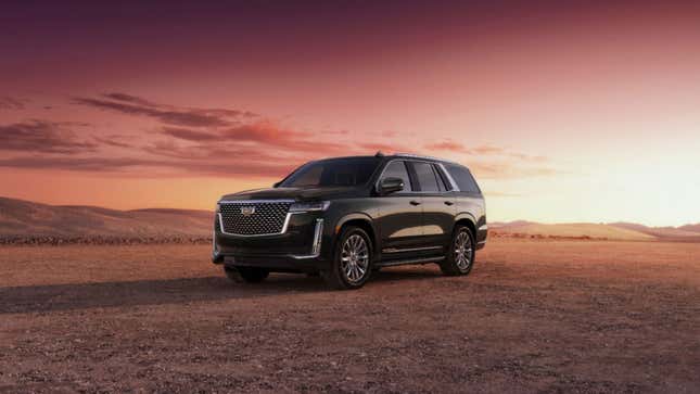 a photo of a black Cadillac Escalade at sunset. 