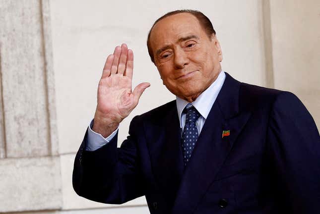 Silvio Berlusconi waves