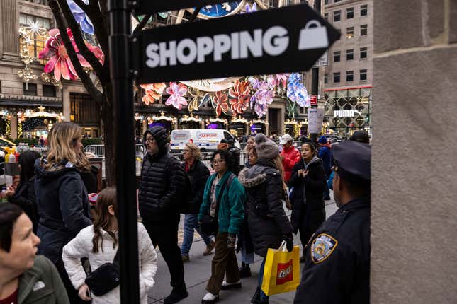 FILE - Shoppers and sightseers walk on Fifth Avenue on Dec. 11, 2023, in New York. In the United States, the economy motored ahead in last year&#39;s fourth quarter for a sixth straight quarter of growth since the pandemic&#39;s early days. (AP Photo/Yuki Iwamura, File)