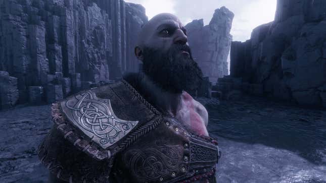 Kratos looks up at something off-screen.