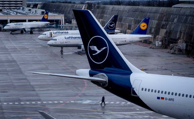 FILE - A person walks near parked Lufthansa aircrafts at the airport in Frankfurt, Germany, on March 26, 2023. A union has called on Lufthansa&#39;s ground staff to walk off the job for a day on Wednesday in a pay dispute, the latest of several transport strikes in the country. The Ver.di union said Monday it is calling on ground staff for the German airline at Frankfurt, Munich, Hamburg, Berlin and Duesseldorf airports to strike from 4 a.m. Wednesday. (AP Photo/Michael Probst, File)