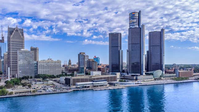 The Renaissance Center (complex of skyscrapers with the Chrevrolet sign) in city urban skyline by the Detroit River.