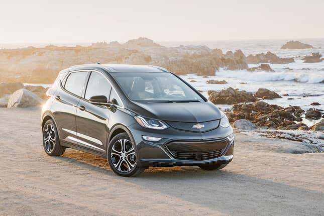 Image of a black Chevrolet Bolt viewed from the front quarter, parked on a beach.