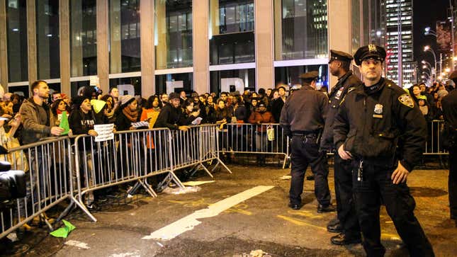 Police keep watch of barricaded protesters.