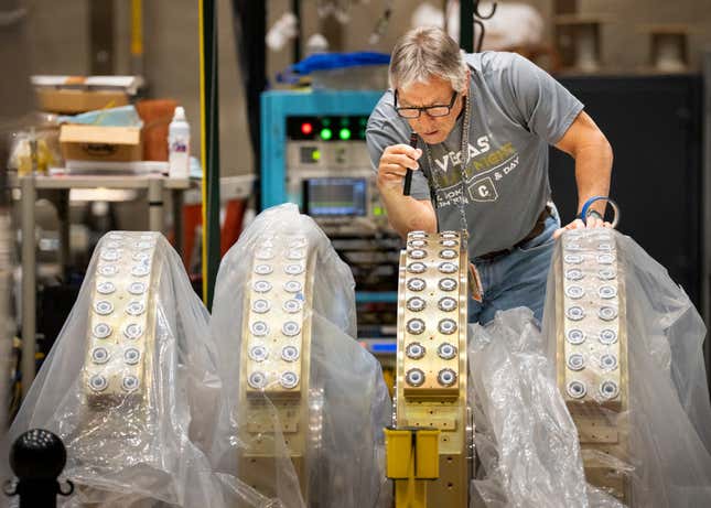 In this photo provided by Sandia National Laboratories, a technician inspects cathode inductive voltage adder cells used in the Scorpius Injector being assembled at Sandia National Labs, June 8, 2023, in Albuquerque, N.M. Unable to physically validate the effectiveness and reliability of nuclear warheads since a 1992 underground test ban, the $1.8 billion Scorpius will allow experts to conduct subcritical experiments as early as 2027 in the atomic equivalent of a wind tunnel built for aircraft prohibited from flying. (Craig Fritz/Sandia National Laboratories via AP)