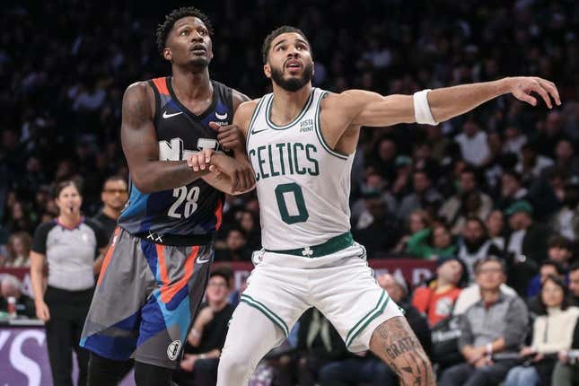 Nov 4, 2023; Brooklyn, New York, USA;  Brooklyn Nets forward Dorian Finney-Smith (28) and Boston Celtics forward Jayson Tatum (0) box out for a rebound in the fourth quarter at Barclays Center.