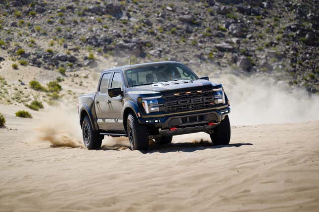 Front 3/4 view of a green 2024 Ford F-150 Raptor R drifting in sand