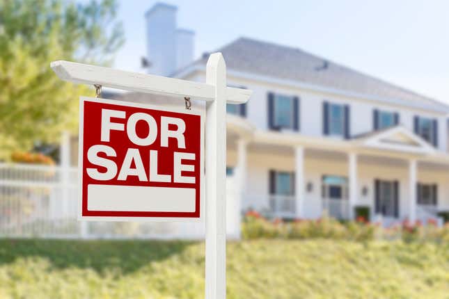 For Sale Sign In Front of House