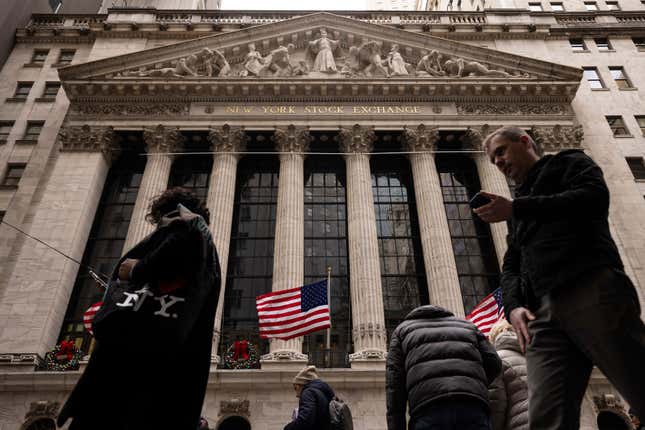 FILE - People walk past the New York Stock Exchange, Dec. 11, 2023, in New York. Just a quarter of business economists and analysts expect the United States to fall into recession in 2024. And any downturn would likely result from an external shock, such as a conflict involving China, rather than from domestic economic factors such as higher interest rates. (AP Photo/Yuki Iwamura, File)