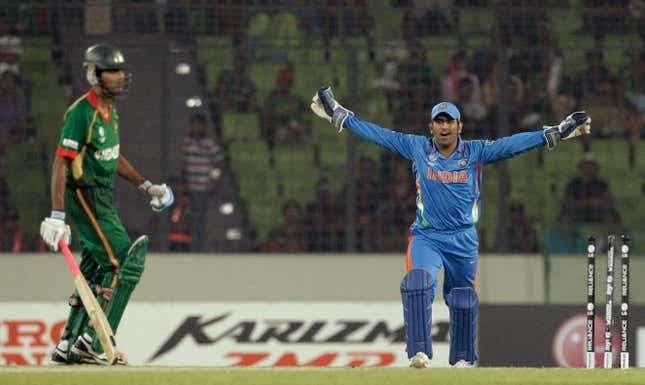 Mahendra Singh Dhoni celebrates during the opening match of 2011 Cricket World Cup in Dhaka, Bangladesh.