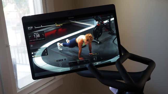 A photo of the Peloton's swivel screen with a fitness class