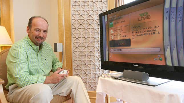 Peter Moore sits in front of an Xbox 360. 