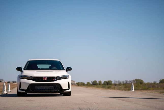 A white 2023 Honda Civic Type R sitting on a race track.