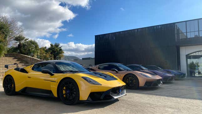 a yellow, bronze, purple and blue GT2 Stradale parked next to eachother