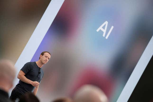 Mark Zuckerberg on stage with a colorful backdrop that says "AI" on it