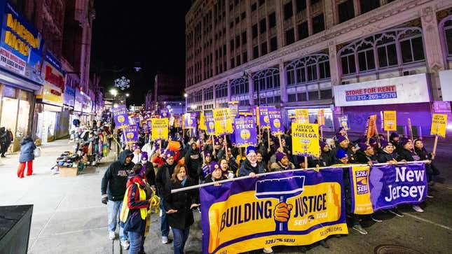 Cleaning workers march through the streets of Newark, New Jersey on Dec. 13. 