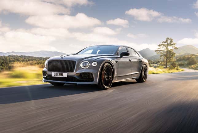 A grey Bentley Flying Spur driving down a rural road.