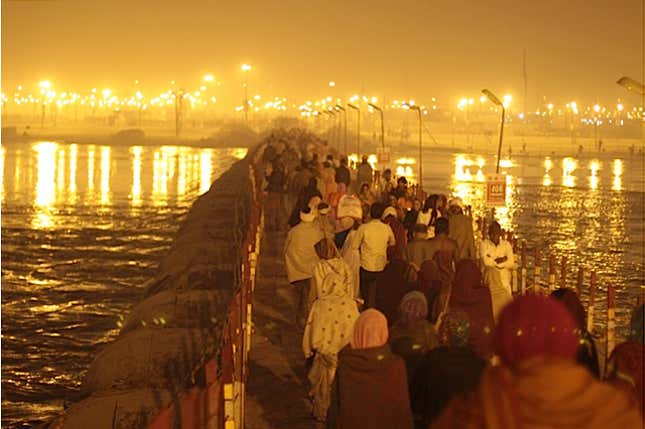 Pilgrims stream across one of many pontoon bridges spanning the Ganga river.