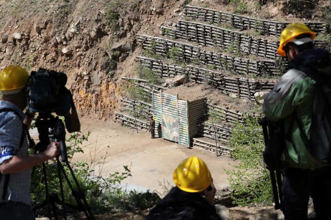 Journalists film the fourth tunnel of Punggye-ri nuclear test ground is seen before it is blown up during the dismantlement process in Punggye-ri, North Hamgyong Province, North Korea May 24, 2018. Picture taken May 24, 2018