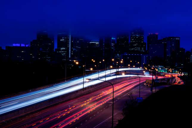 File - In this photo made with a long exposure, vehicles move along Interstate 76 ahead of the Thanksgiving Day holiday in Philadelphia, Nov. 22, 2023. A big explanation for the recent decline in gas prices is seasonality — with prices at the pump almost always easing at this time of year. (AP Photo/Matt Rourke, File)