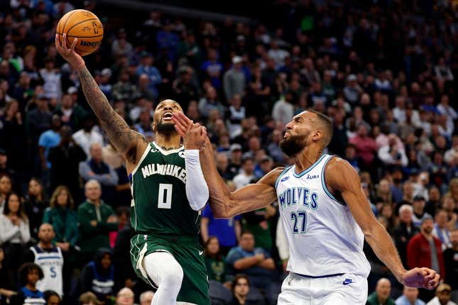 MINNEAPOLIS, MINNESOTA - FEBRUARY 23: Damian Lillard #0 of the Milwaukee Bucks goes up for a shot against Rudy Gobert #27 of the Minnesota Timberwolves in the fourth quarter at Target Center on February 23, 2024 in Minneapolis, Minnesota. The Bucks defeated the Timberwolves 112-107. NOTE TO USER: User expressly acknowledges and agrees that, by downloading and or using this photograph, User is consenting to the terms and conditions of the Getty Images License Agreement. (Photo by David Berding/Getty Images)