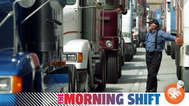 LONG BEACH, UNITED STATES: A truck driver smokes a cigarette as he waits in a queue to enter the island terminal to load his truck at the Port of Long Beach docks in Long Beach, CA, 10 October 2002. A federal court granted a temporary injunction ending the lockout that has bottled up ports from San Diego to Seattle. The Bush administration offered the 30-day extension to avoid having to invoke the Taft-Hartley Act, which imposes an 80-day cooling-off period that would force the ports to reopen.
