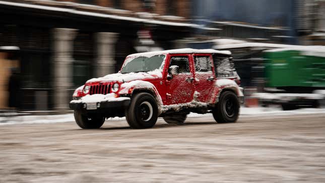Image of a car driving on Lower Broadway covered in snow after a snow storm on January 15, 2024 in Nashville, Tennessee.