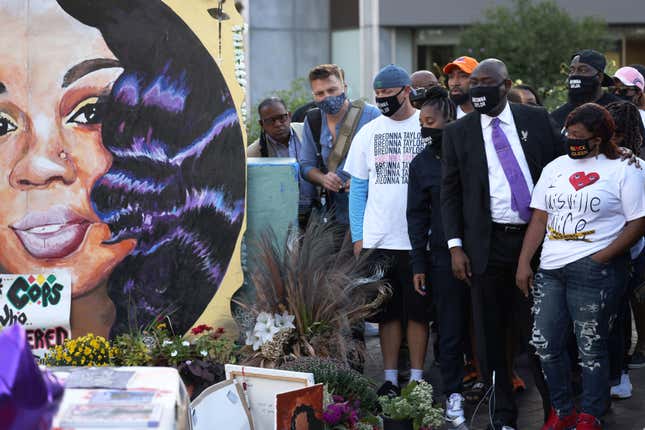 LOUISVILLE, KENTUCKY - SEPTEMBER 25: National civil rights and personal injury attorney Ben Crump places his hands on the shoulders Tamika Palmer, Breonna Taylor’s mother, as as she looks at a mural of her daughter at Jefferson Square Park on September 25, 2020 in Louisville, Kentucky.