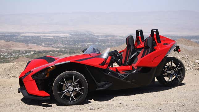 A photo of a red Polaris slingshot trike. 