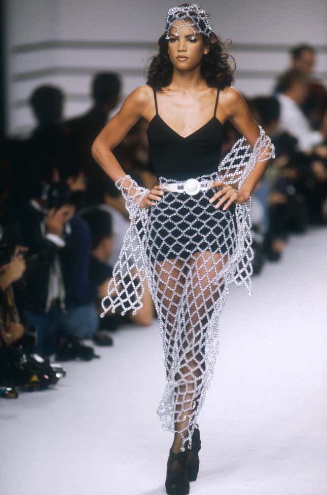 Supermodel Veronica Webb models a women’s ready-to-wear black minidress with netting by German fashion designer Karl Lagerfeld at his Spring-Summer 1992 fashion show in Paris.