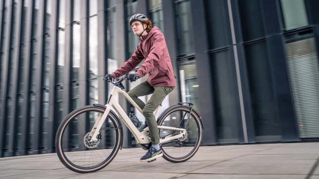 A photo of a person riding the Orbea Diem e-bike through a city. 