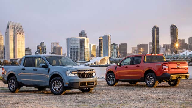 Two Ford maverick pickup trucks in front of a city skyline