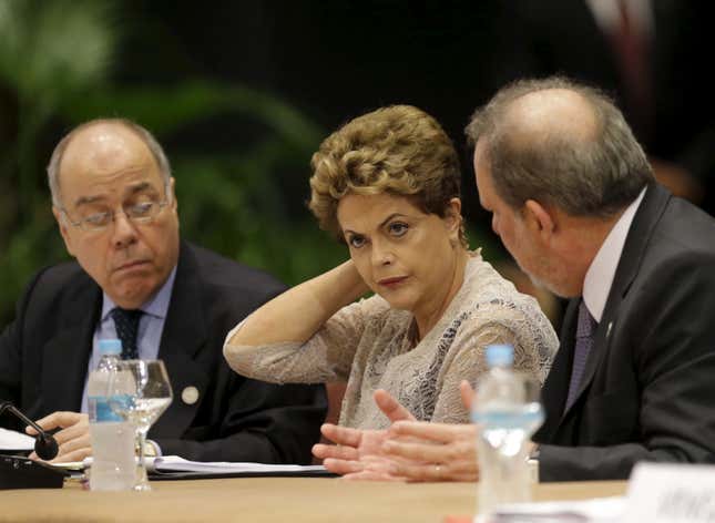 Brazil's Foreign Minister Mauro Viera (L), Brazil's President Dilma Rousseff (C) and Brazil's Minister for Development, Industry and Trade Armando Monteiro attend a session of the Summit of Heads of State of MERCOSUR and Associated States and 49th Meeting of the Common Market Council in Luque, Paraguay.