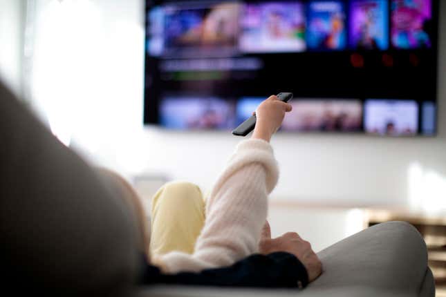 Family on a couch watching TV at home