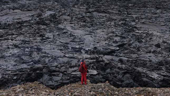 A person standing at the Fagradalsfjall lava field in 2021.