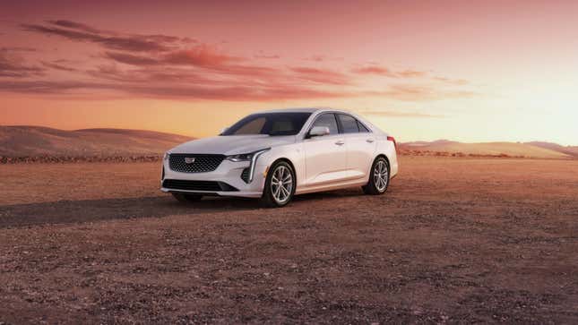 A white Cadillac CT4 in a desert during a sunset