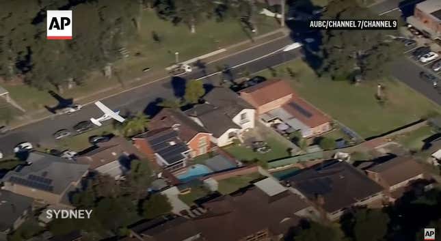 a small Cessna plane flys dangerously close to a neighborhood
