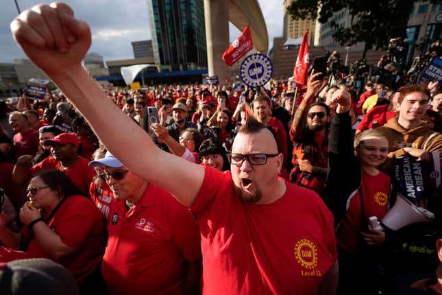 United Auto Workers member Brian Rooster Heppner raises his fist as he cheers during a rally in Detroit, Friday, Sept. 15, 2023. The UAW is conducting a strike against Ford, Stellantis and General Motors. (AP Photo/Paul Sancya)